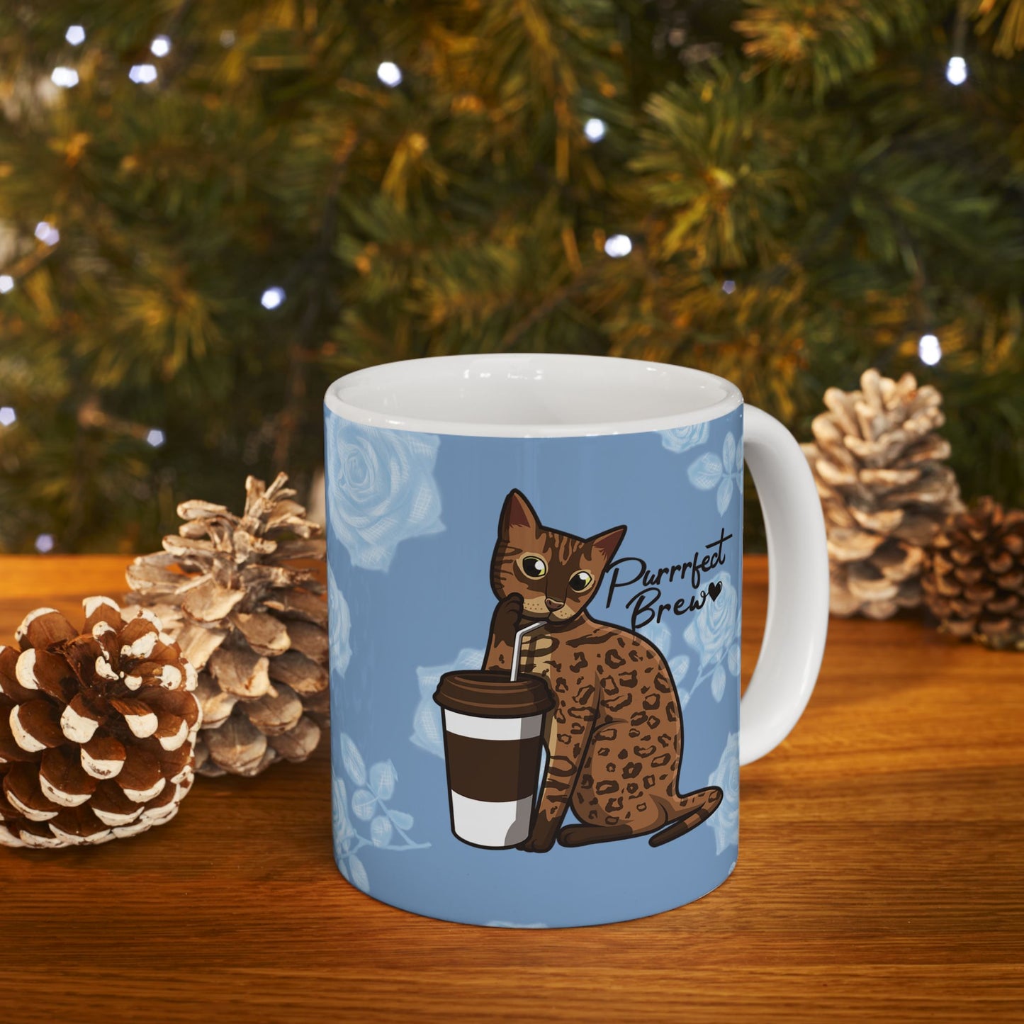 Mug with a Bengal cat drinking from a coffee cup and 'Purrrfect Brew' text on a blue floral patterned background.