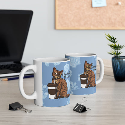 Mug with a Bengal cat drinking from a coffee cup and 'Purrrfect Brew' text on a blue floral patterned background.