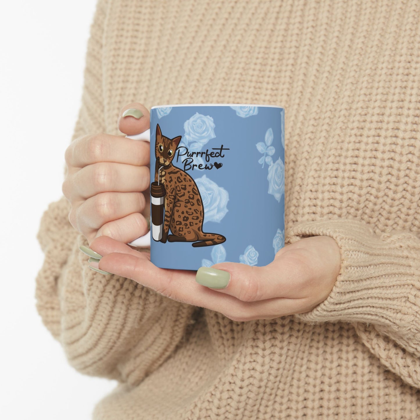 Mug with a Bengal cat drinking from a coffee cup and 'Purrrfect Brew' text on a blue floral patterned background.