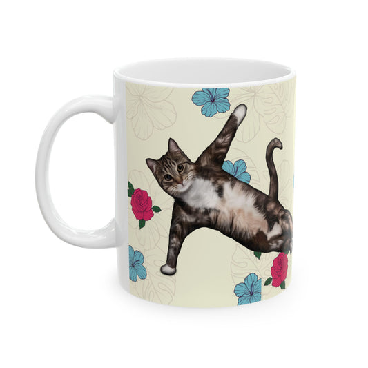Mug with a cat in a yoga pose on a floral background.