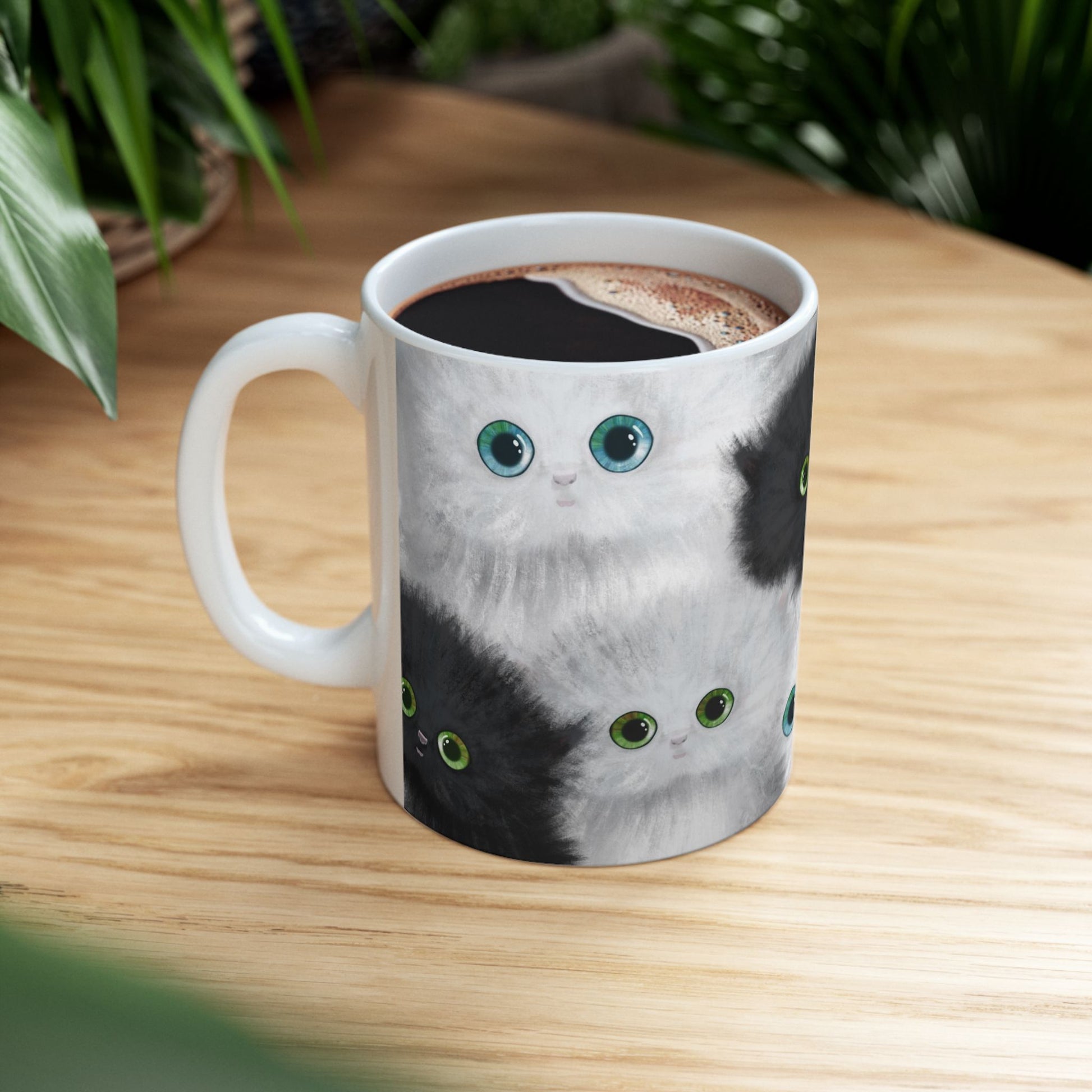 Mug with a design of black and white kittens.