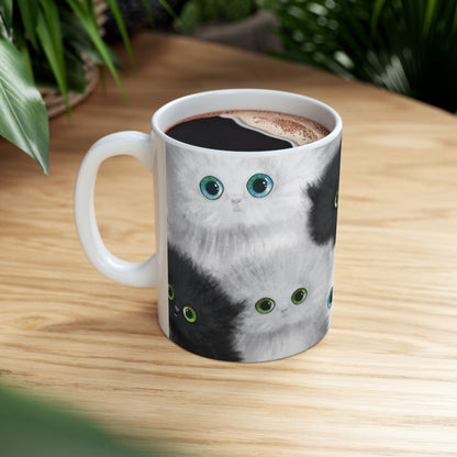 Mug with a design of black and white kittens.
