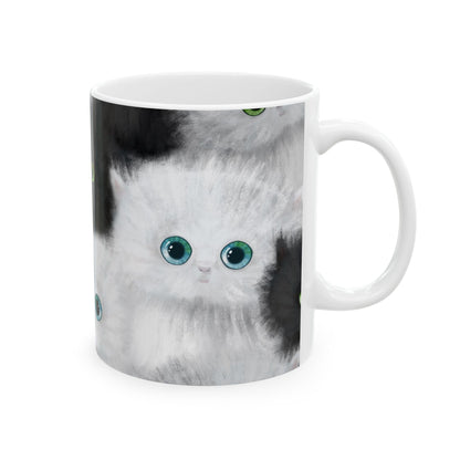 Mug with a design of black and white kittens.
