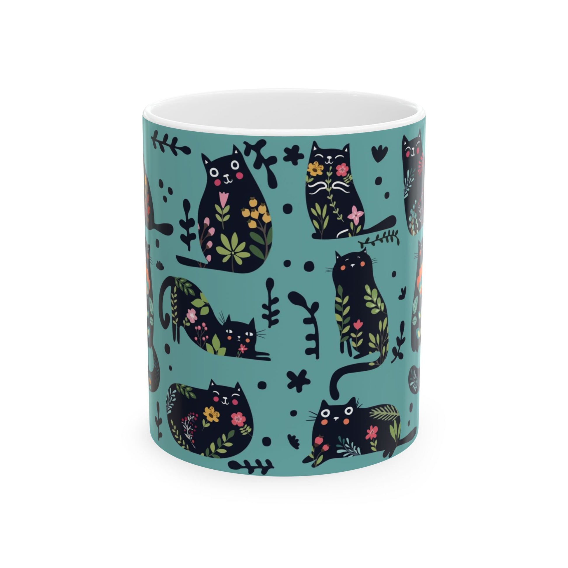 Mug with black cats and floral pattern on a blue background.