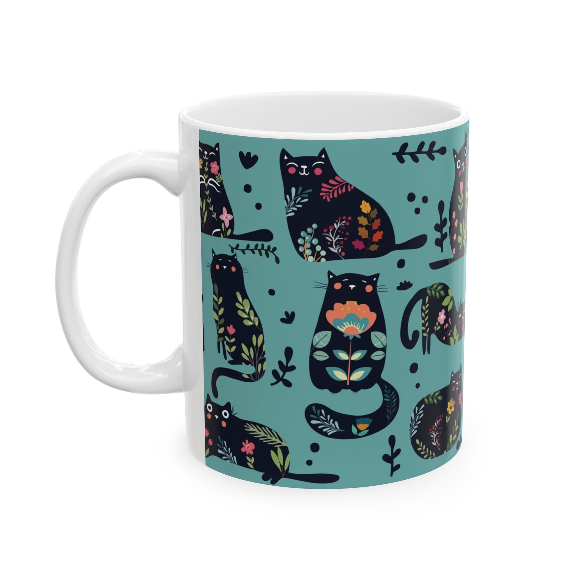 Mug with black cats and floral pattern on a blue background.