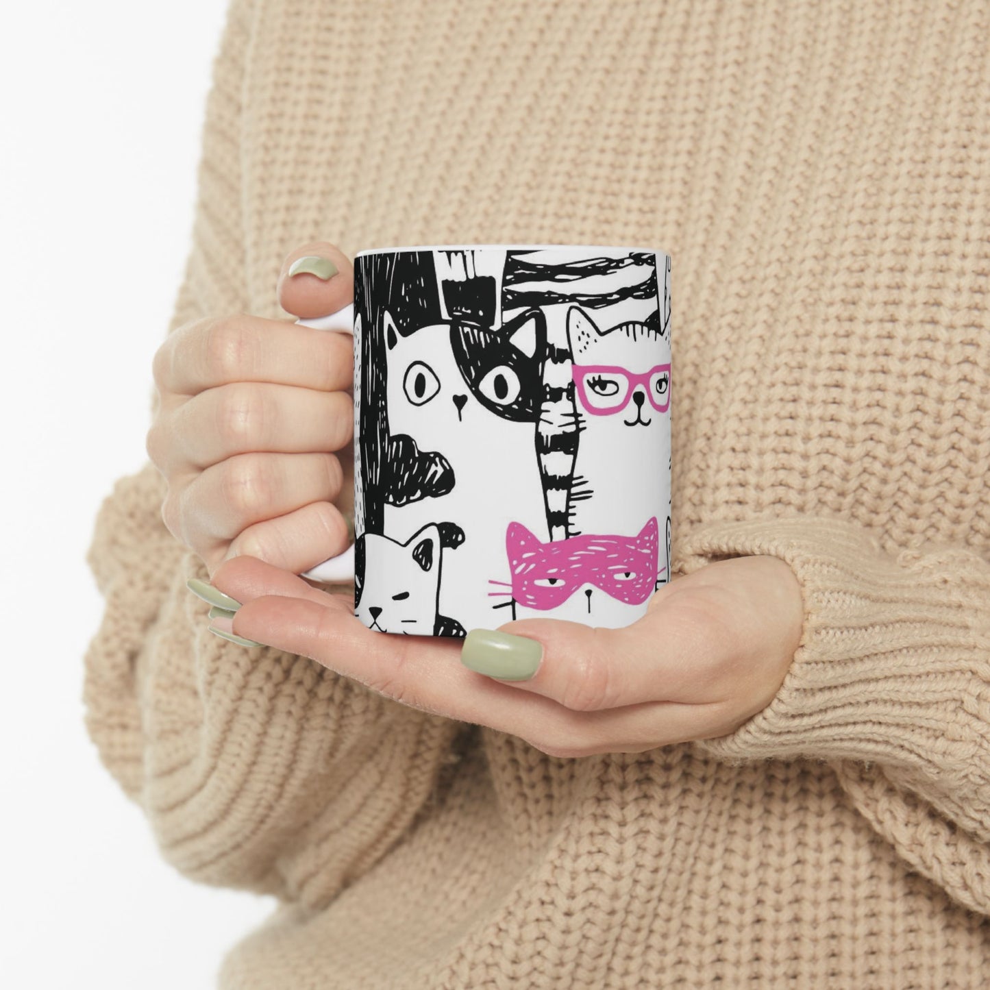 White mug with cartoon black and white cat illustrations.