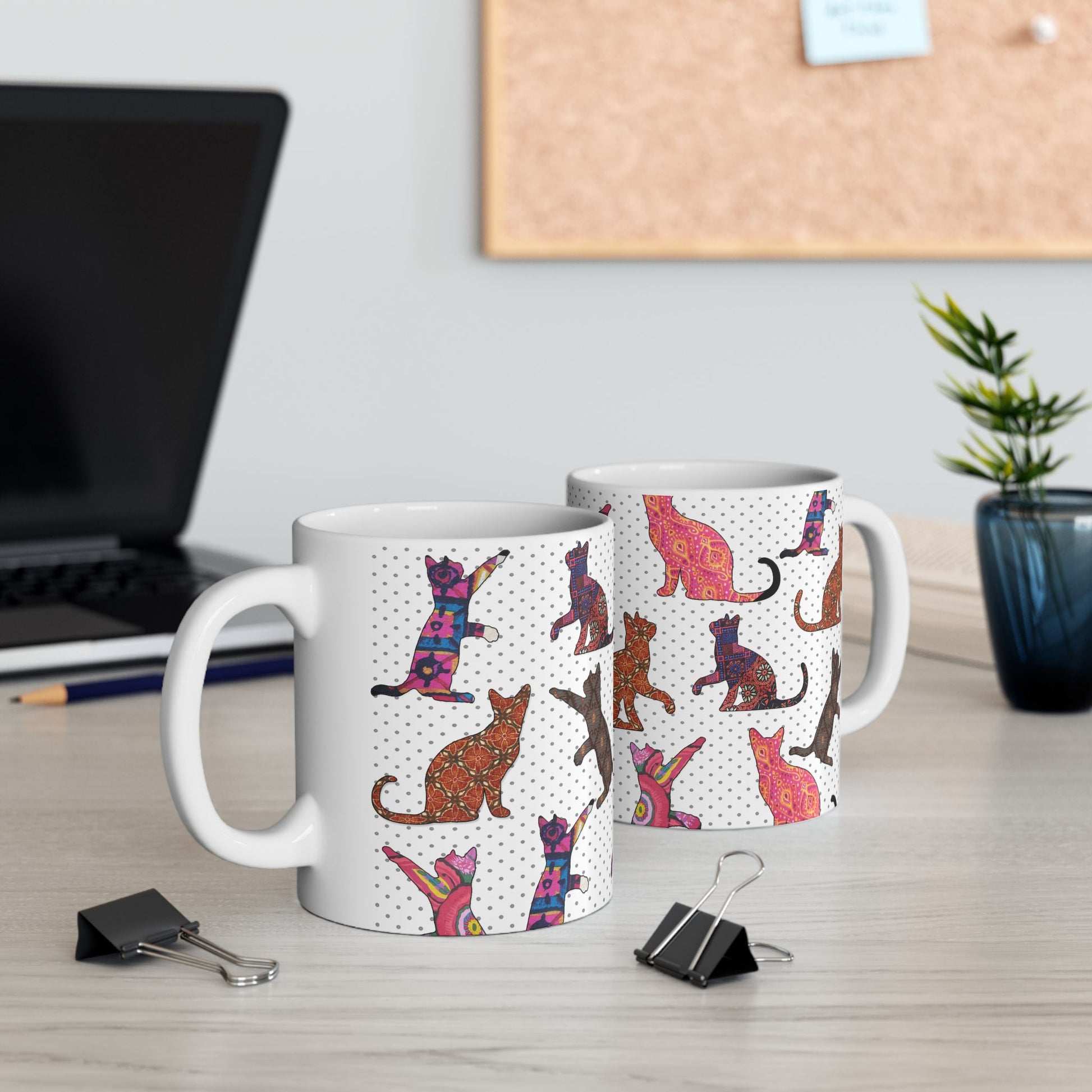 White mug with colorful cat pattern. 