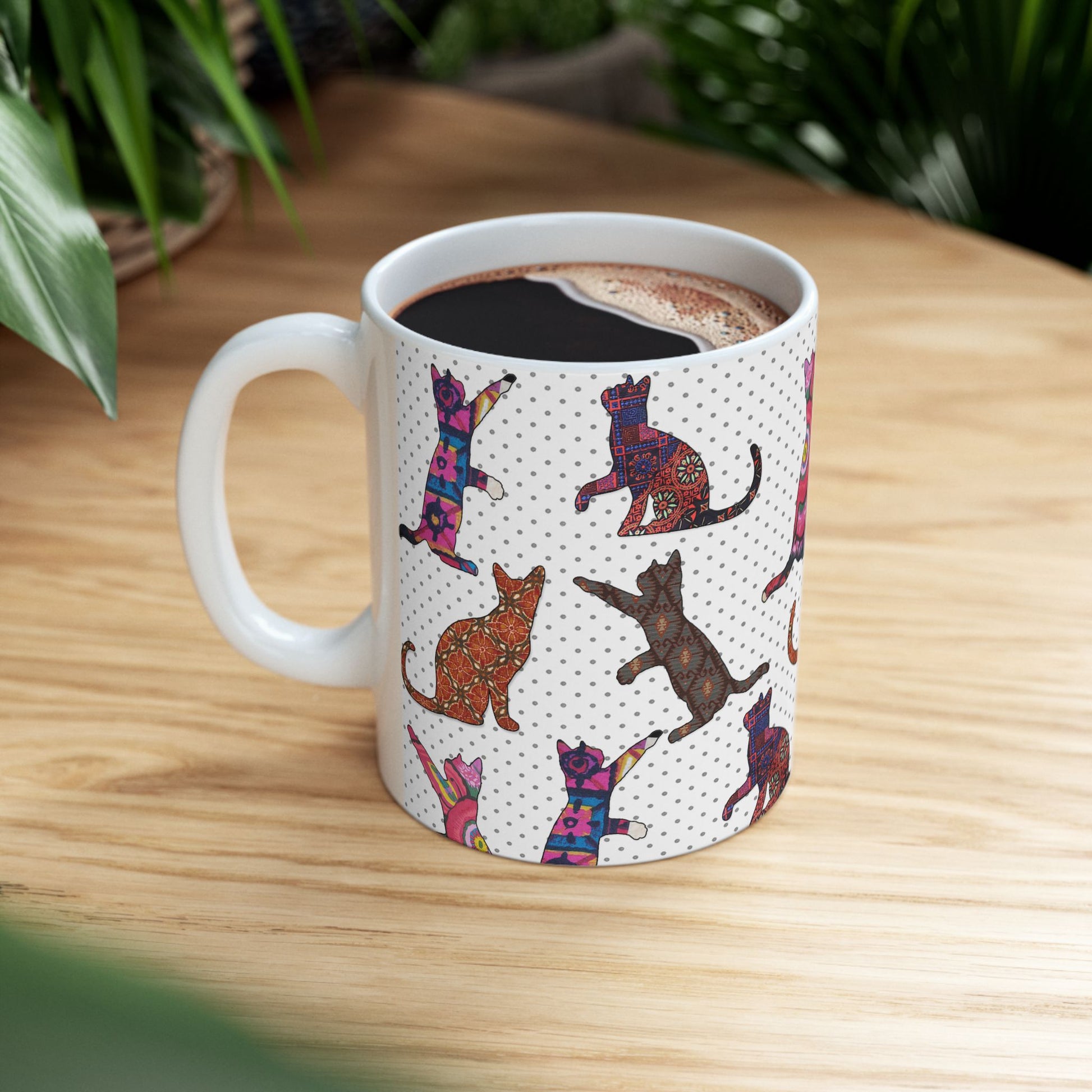 White mug with colorful cat pattern. 