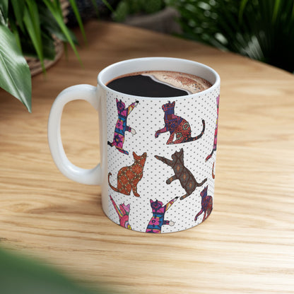 White mug with colorful cat pattern. 