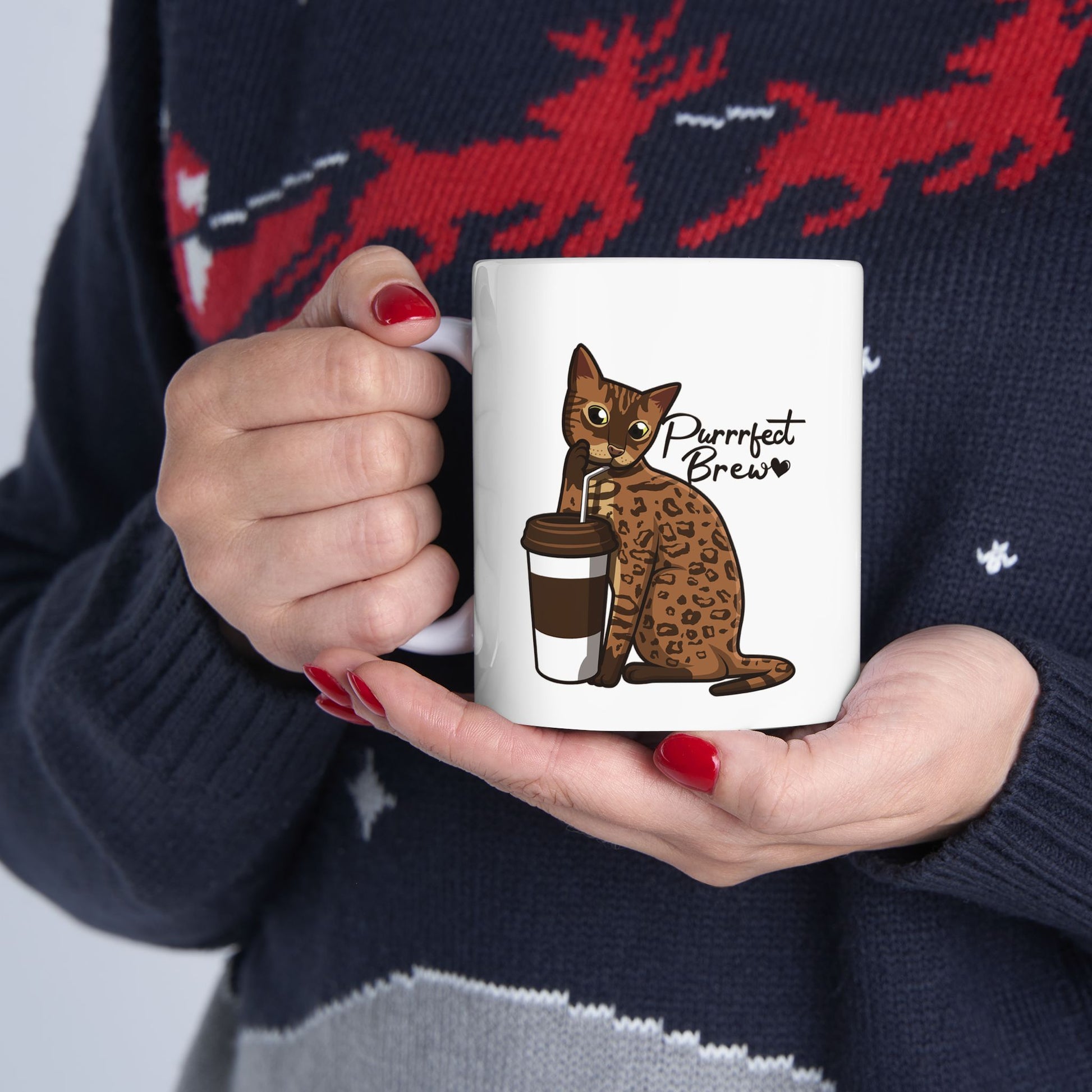 White mug with illustration of a Bengal Cat posing with a coffee cup and text 'Purrrfect Brew.'  