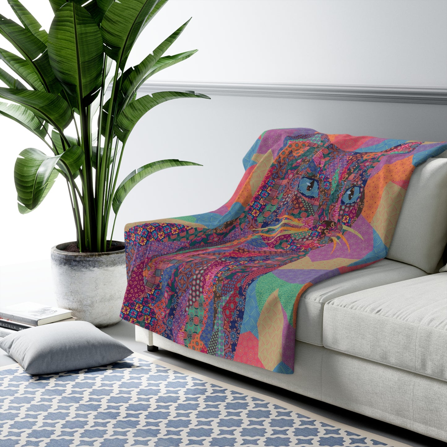 Multicolor fleece indoor throw blanket with a geometric graphic of a cat.