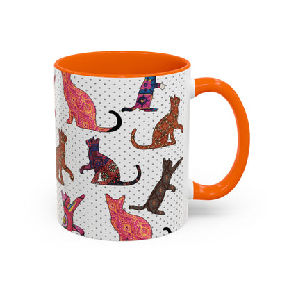 Orange mug with colorful cat silhouette pattern.