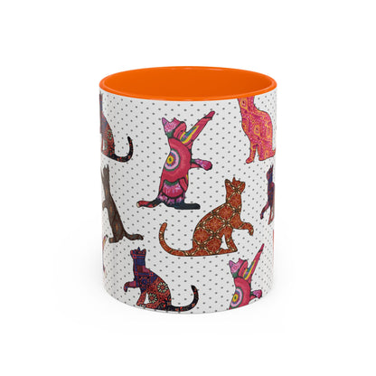 Orange mug with colorful cat silhouette pattern.