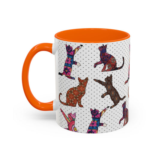 Orange mug with colorful cat silhouette pattern.