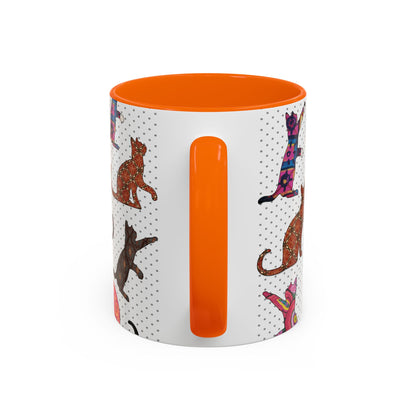 Orange mug with colorful cat silhouette pattern.