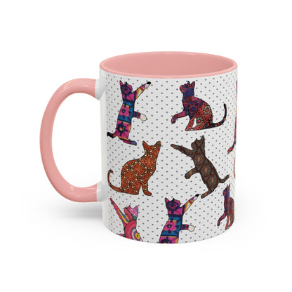 Pink mug with colorful cat silhouette pattern.