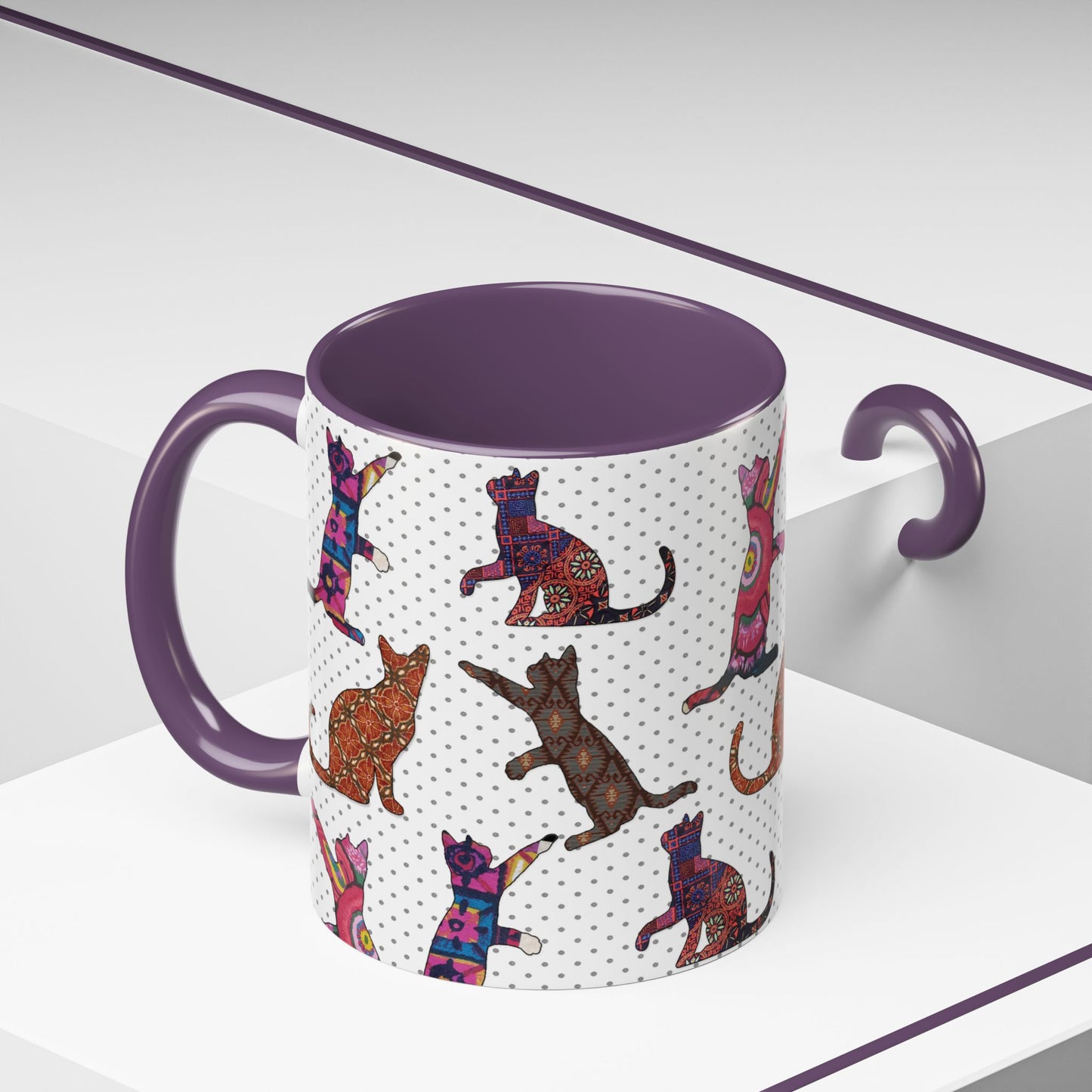 Purple mug with colorful cat silhouette pattern.
