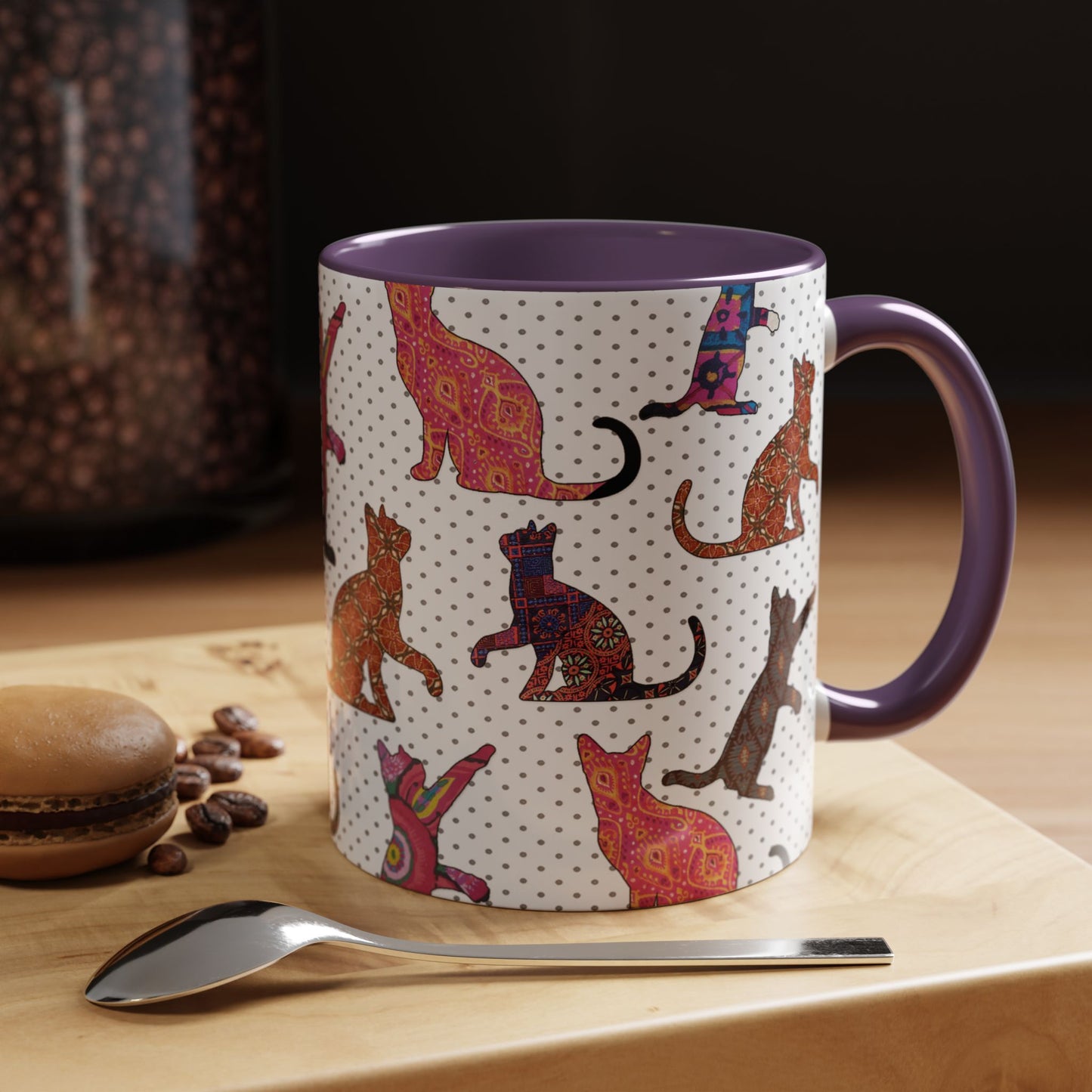 Purple mug with colorful cat silhouette pattern.