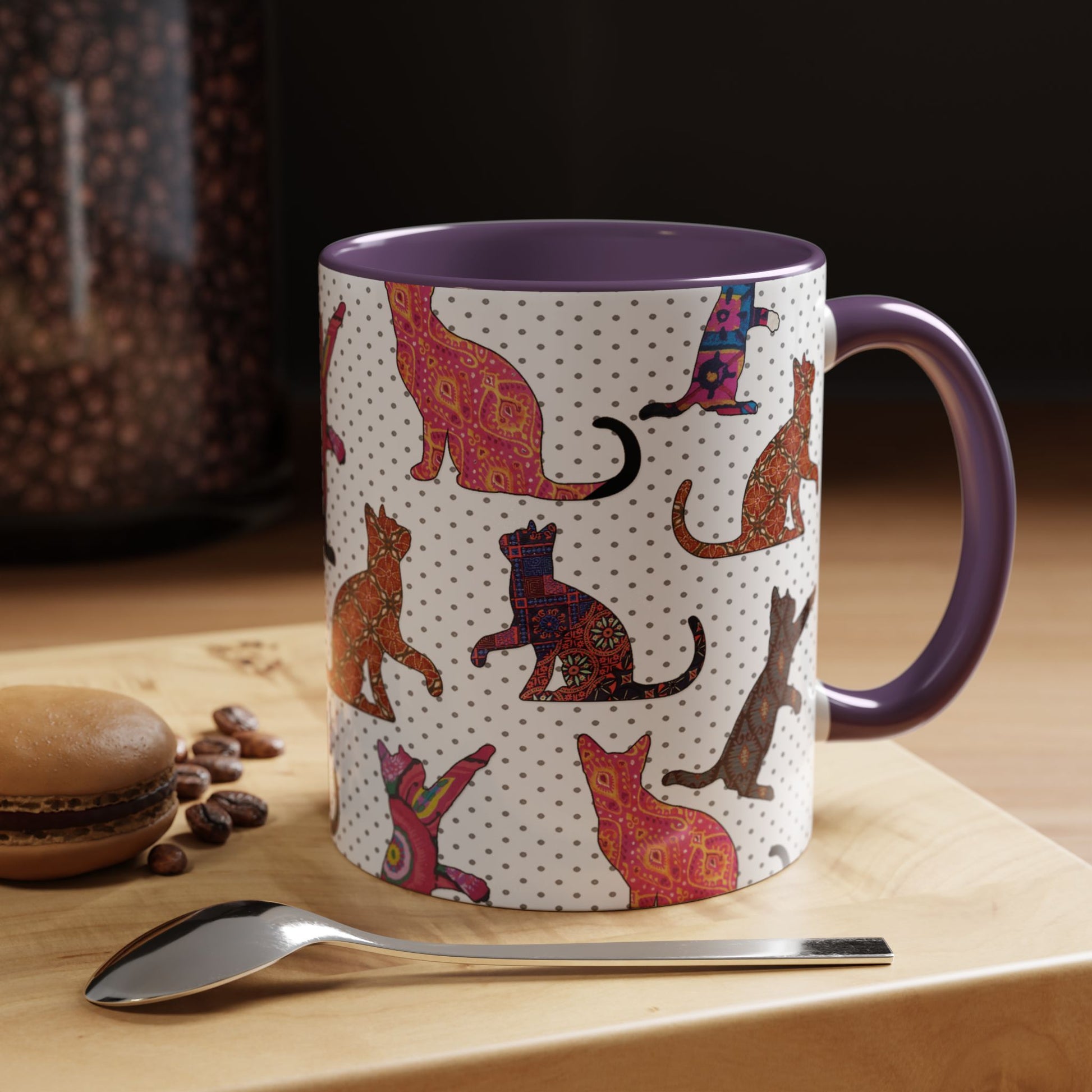 Purple mug with colorful cat silhouette pattern.