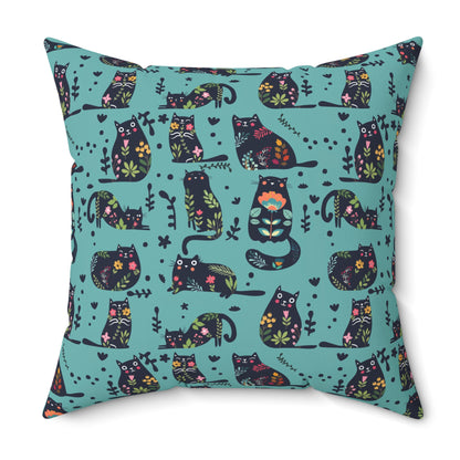 Square throw  pillow with illustrated cartoon cats and floral petal motif on a teal background