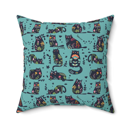 Square throw  pillow with illustrated cartoon cats and floral petal motif on a teal background