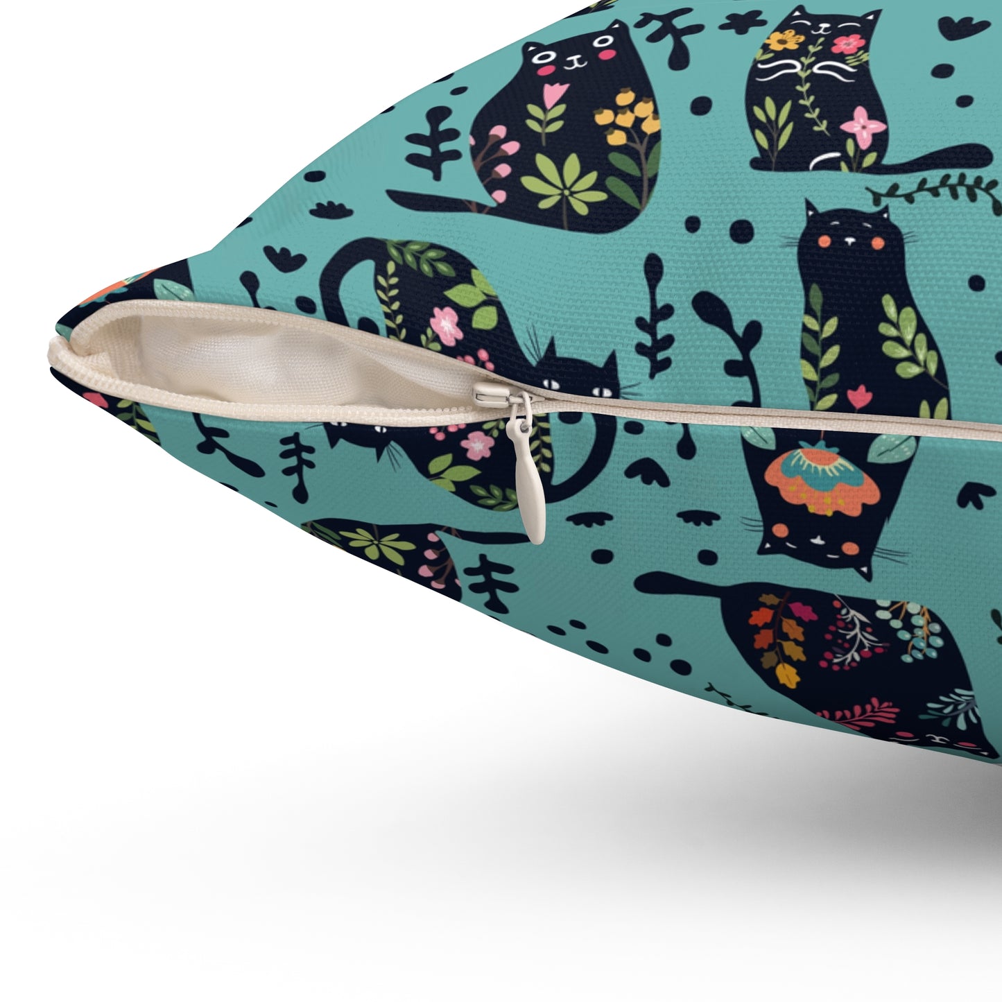 Square throw  pillow with illustrated cartoon cats and floral petal motif on a teal background