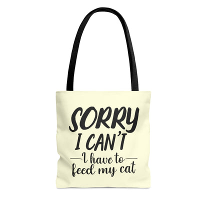 Tote bag with 'Sorry I Can't, I Have to Feed My Cat' text on a cream background