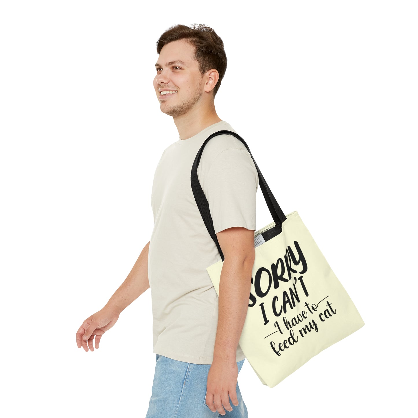 Tote bag with 'Sorry I Can't, I Have to Feed My Cat' text on a cream background
