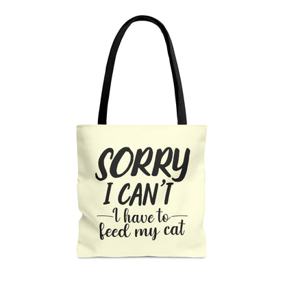 Tote bag with 'Sorry I Can't, I Have to Feed My Cat' text on a cream background