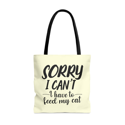 Tote bag with 'Sorry I Can't, I Have to Feed My Cat' text on a cream background
