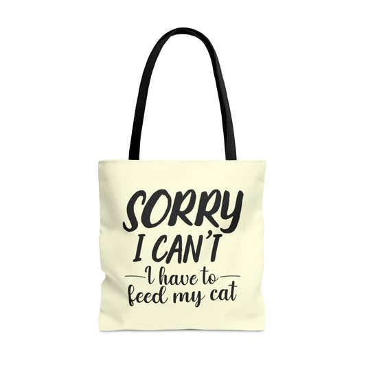 Tote bag with 'Sorry I Can't, I Have to Feed My Cat' text on a cream background