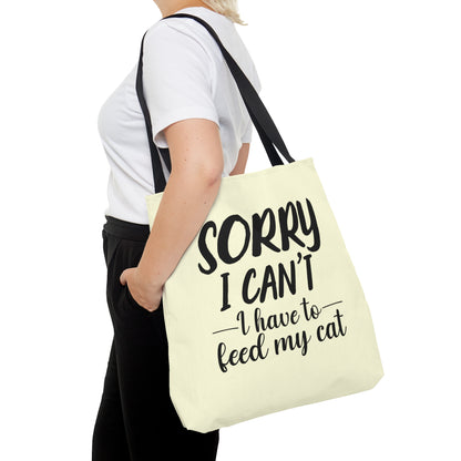 Tote bag with 'Sorry I Can't, I Have to Feed My Cat' text on a cream background