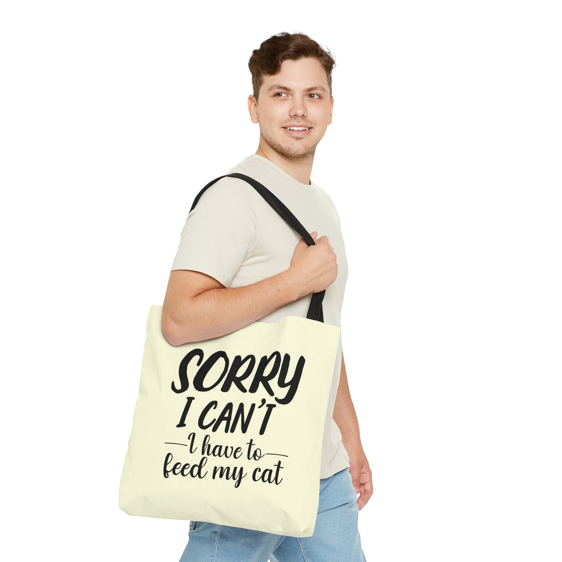 Tote bag with 'Sorry I Can't, I Have to Feed My Cat' text on a cream background