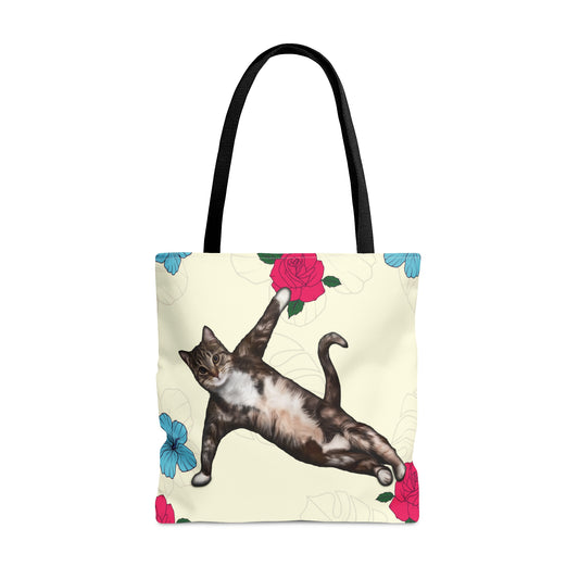 Tote bag with a cat in a yoga pose illustration against floral design on a cream background