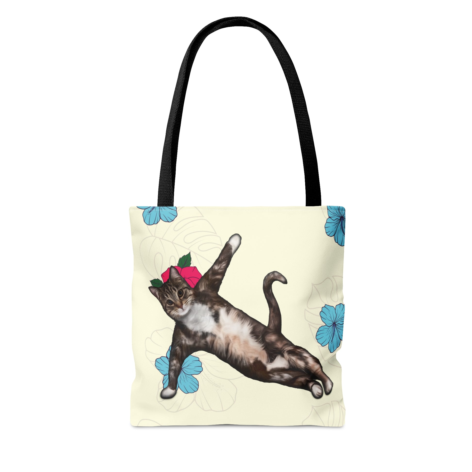 Tote bag with a cat in a yoga pose illustration against floral design on a cream background
