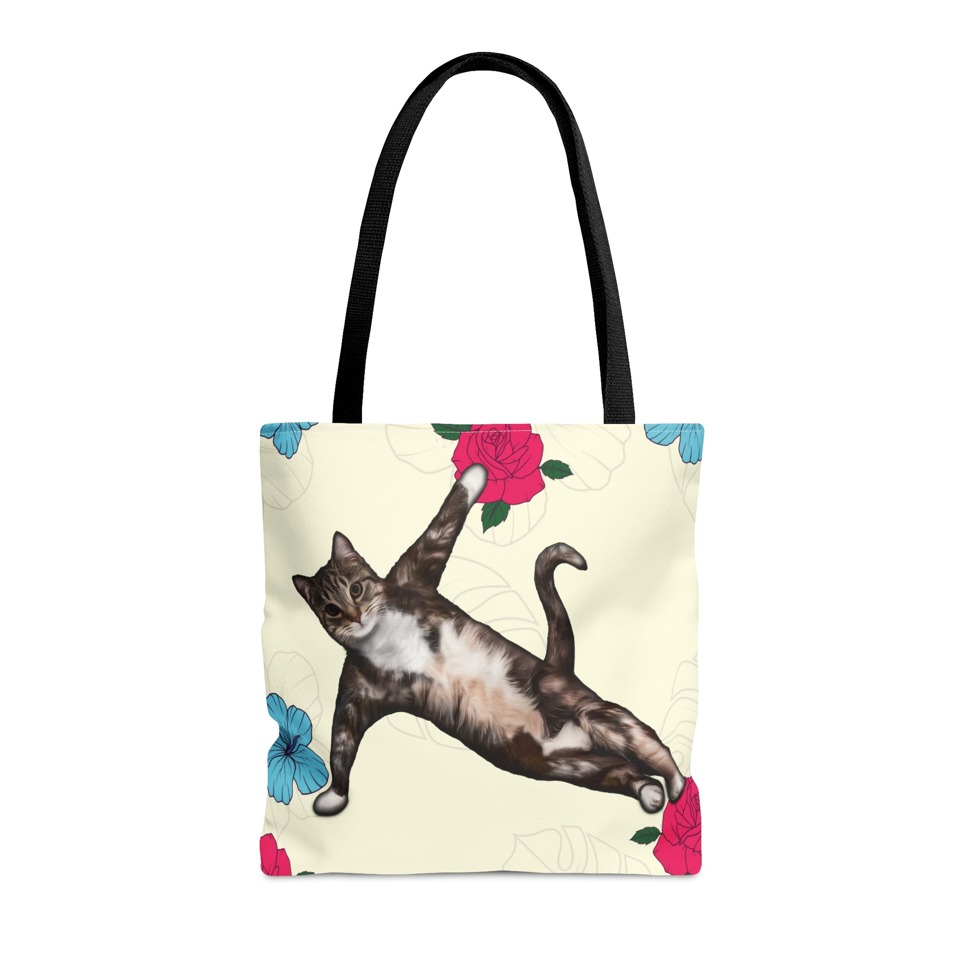 Tote bag with a cat in a yoga pose illustration against floral design on a cream background