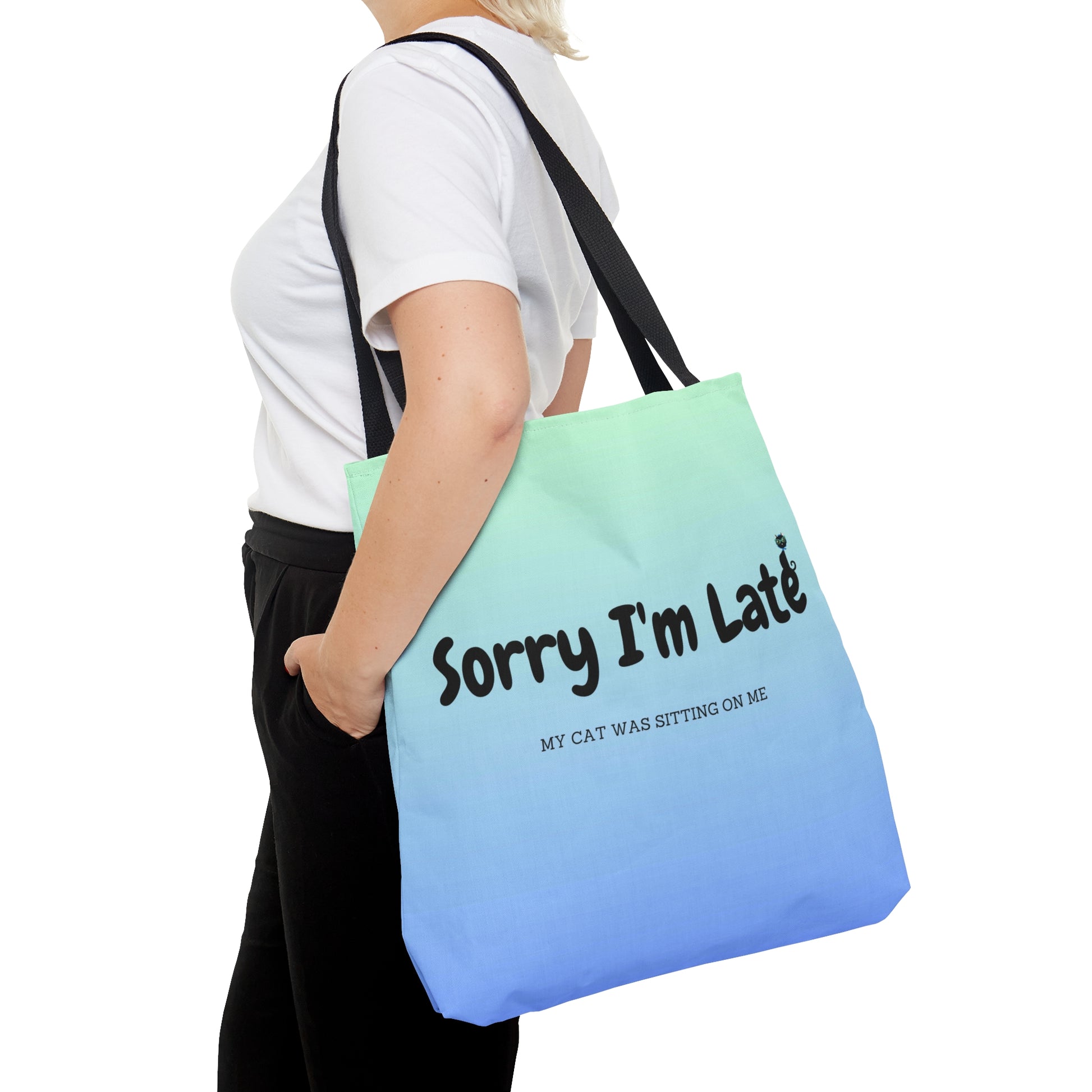 Tote bag with the text "Sorry I'm Late My Cat Was Sitting On Me" and black and white cat illustrations. 