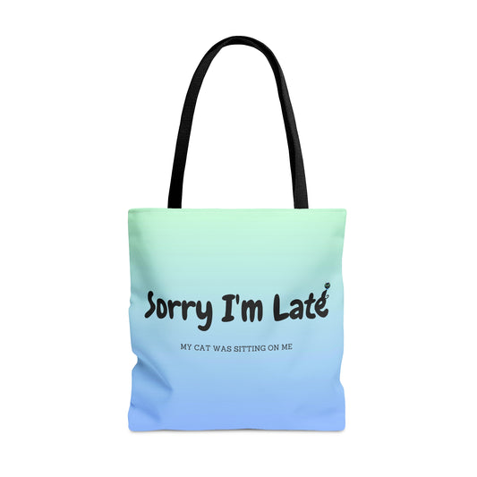 Tote bag with the text "Sorry I'm Late My Cat Was Sitting On Me" and black and white cat illustrations. 