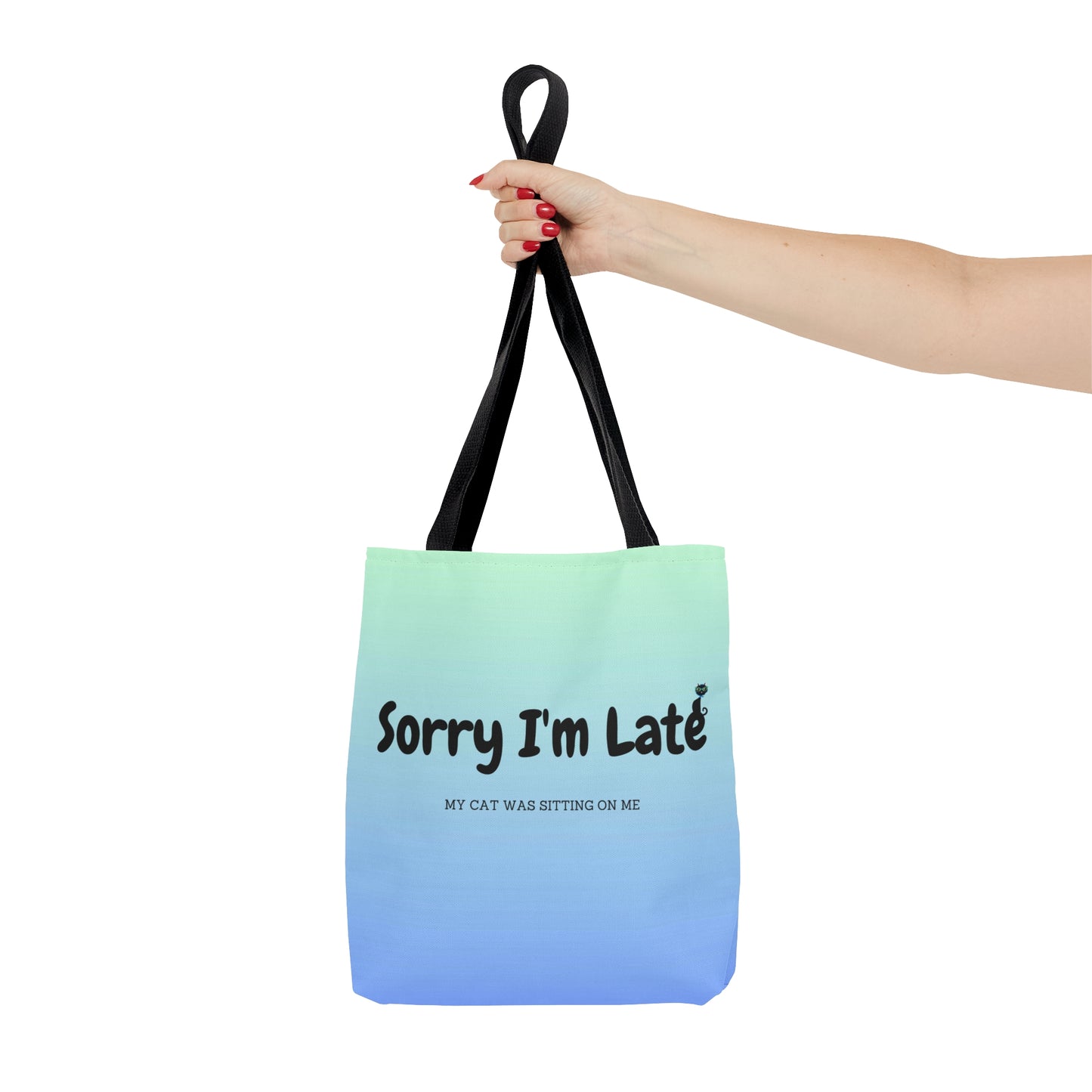 Tote bag with the text "Sorry I'm Late My Cat Was Sitting On Me" and black and white cat illustrations. 