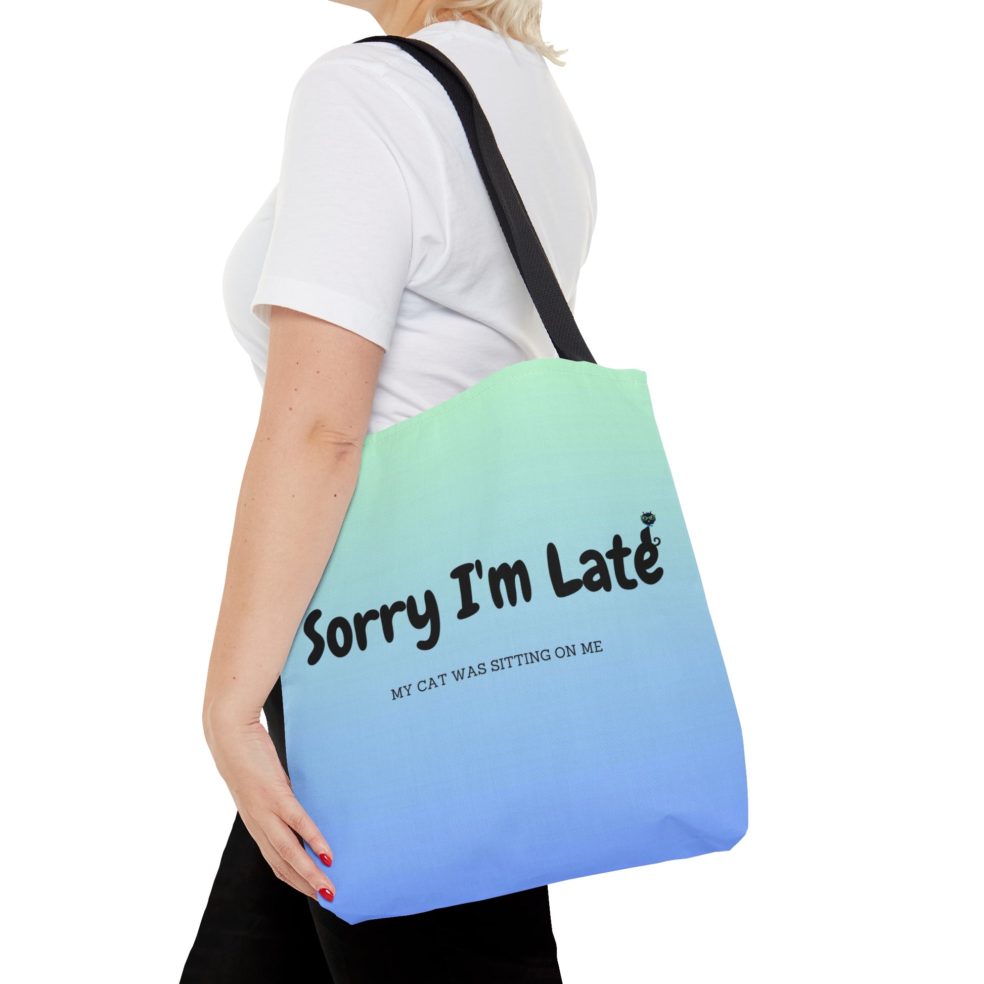 Tote bag with the text "Sorry I'm Late My Cat Was Sitting On Me" and black and white cat illustrations. 