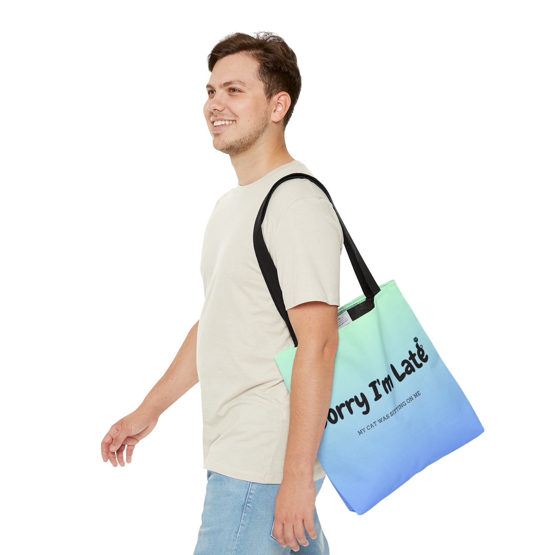 Tote bag with the text "Sorry I'm Late My Cat Was Sitting On Me" and black and white cat illustrations. 