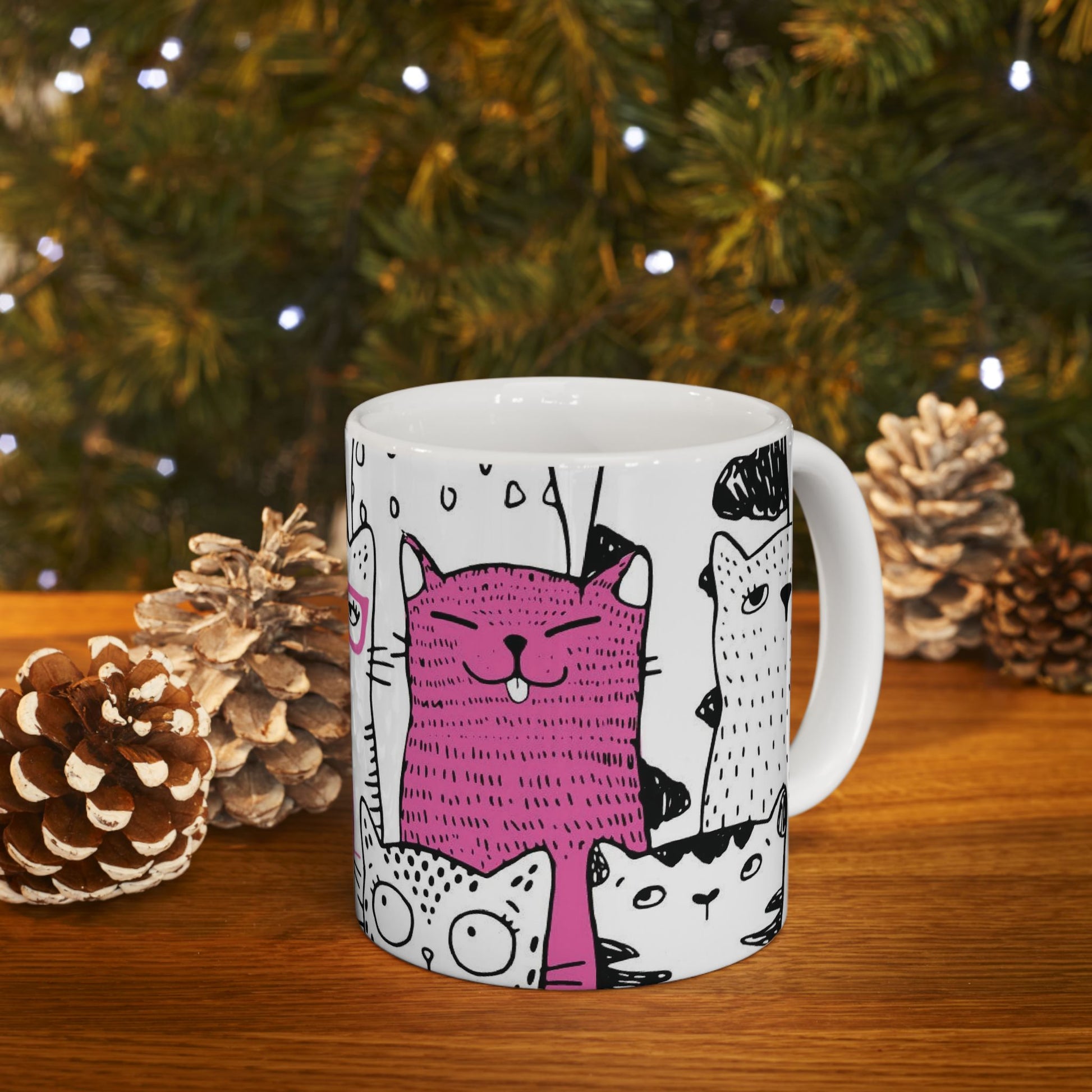 White mug with cartoon black and white cat illustrations.