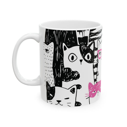 White mug with cartoon black and white cat illustrations.