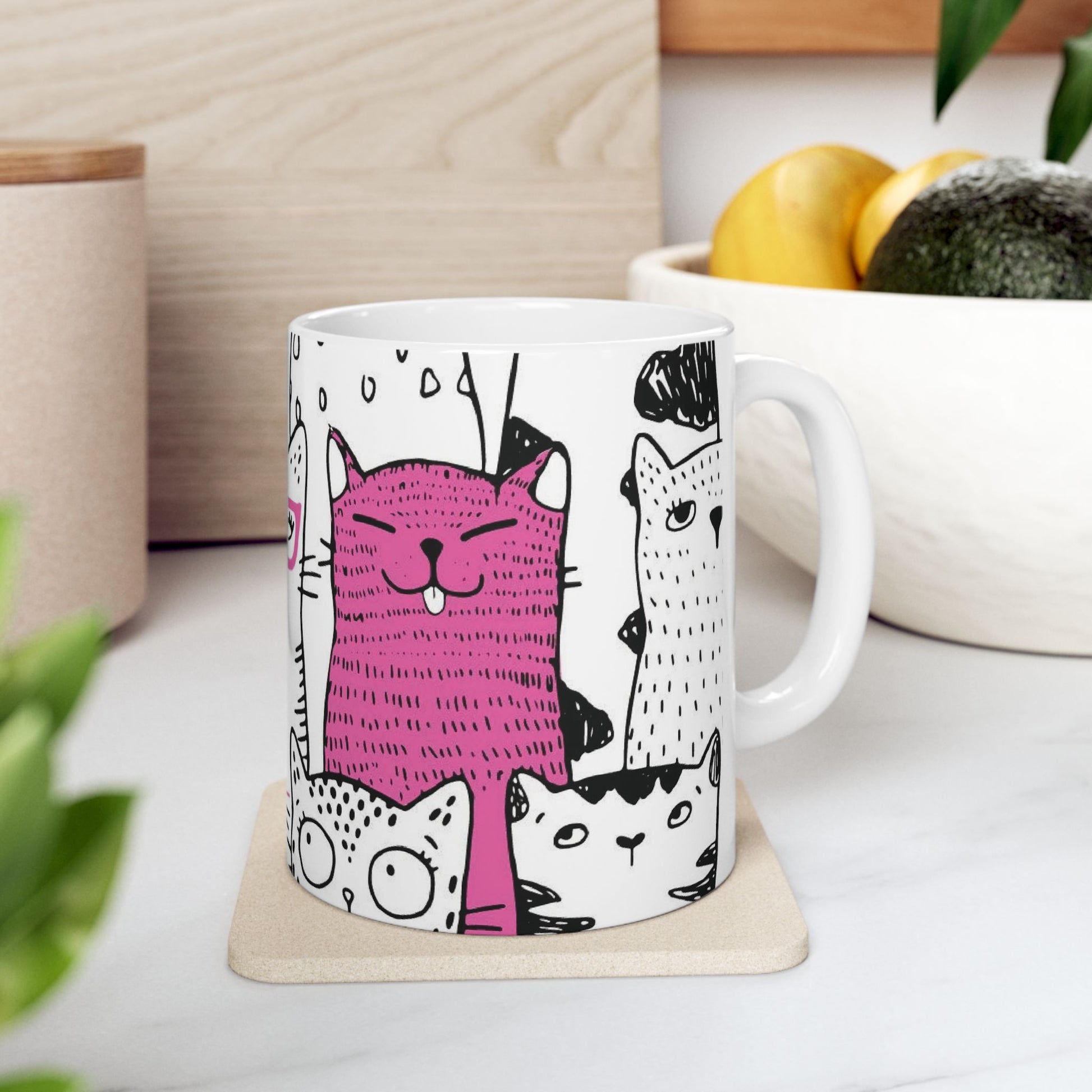 White mug with cartoon black and white cat illustrations.
