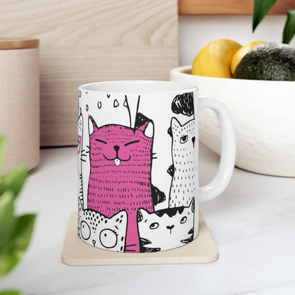 White mug with cartoon black and white cat illustrations.