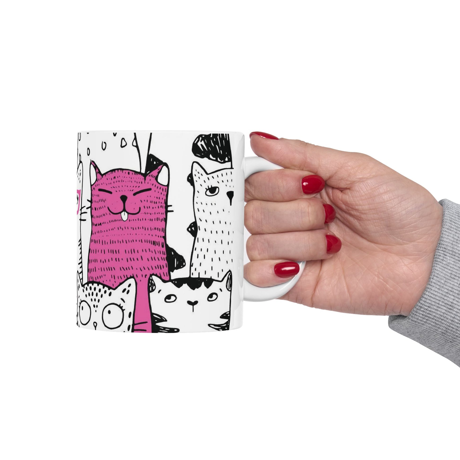White mug with cartoon black and white cat illustrations.