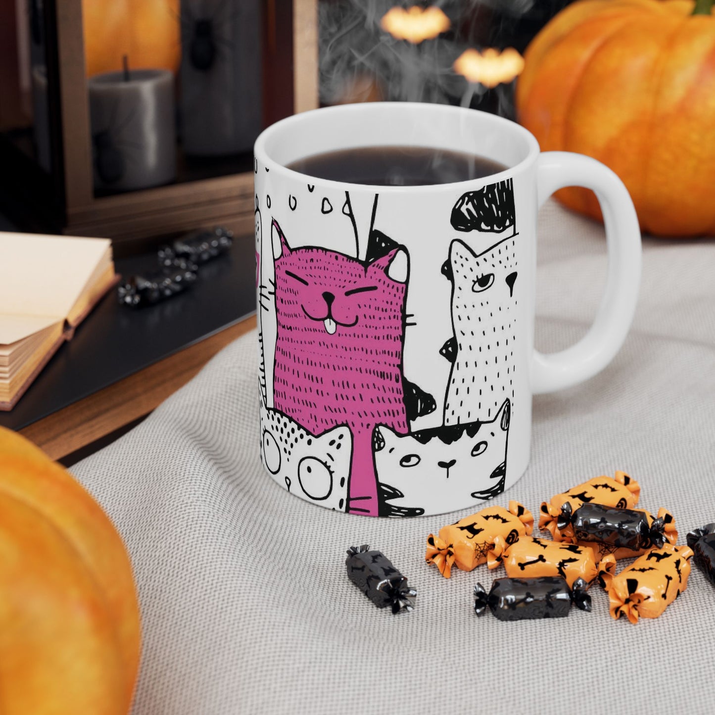White mug with cartoon black and white cat illustrations.