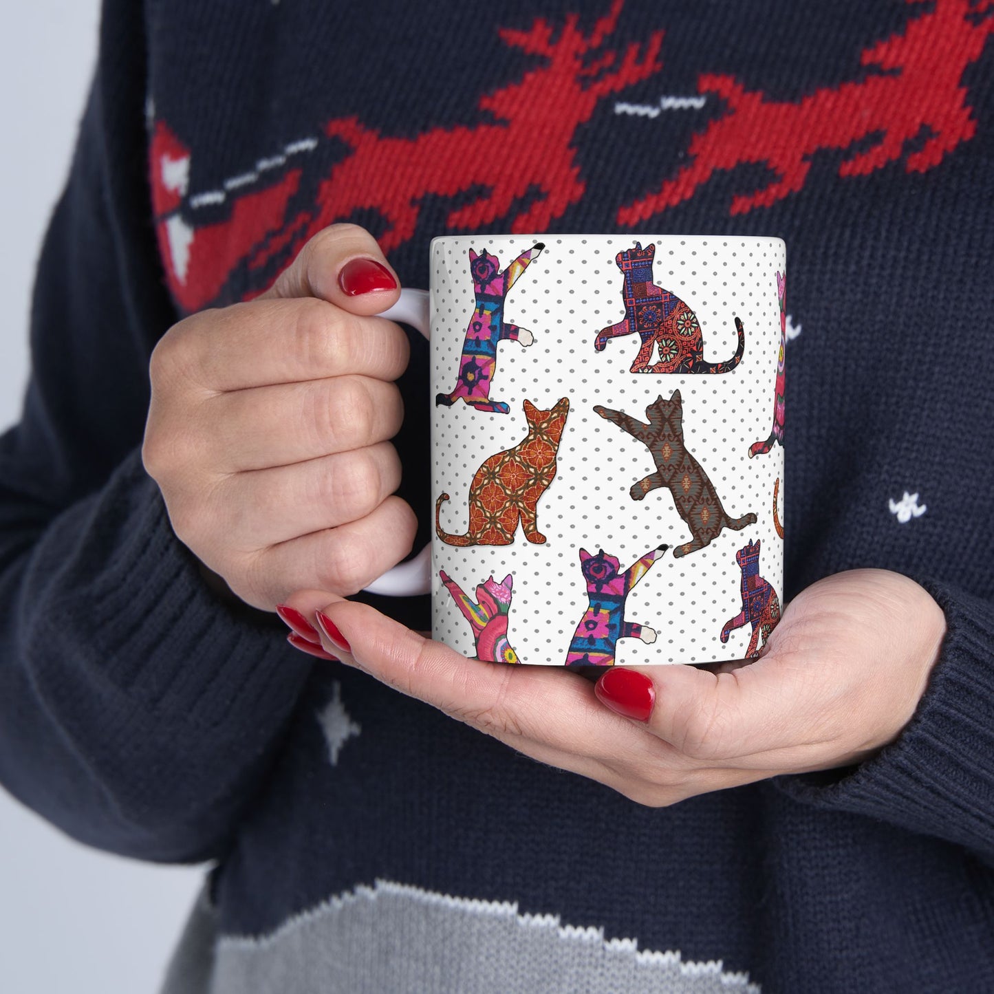 White mug with colorful cat pattern. 
