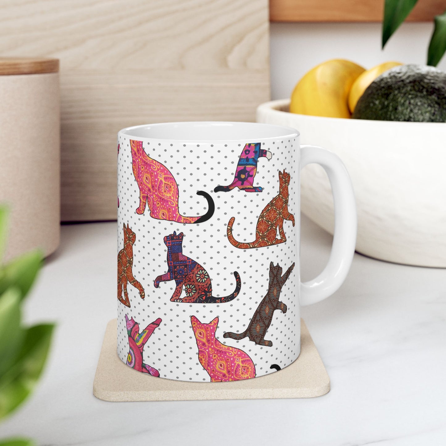 White mug with colorful cat pattern. 