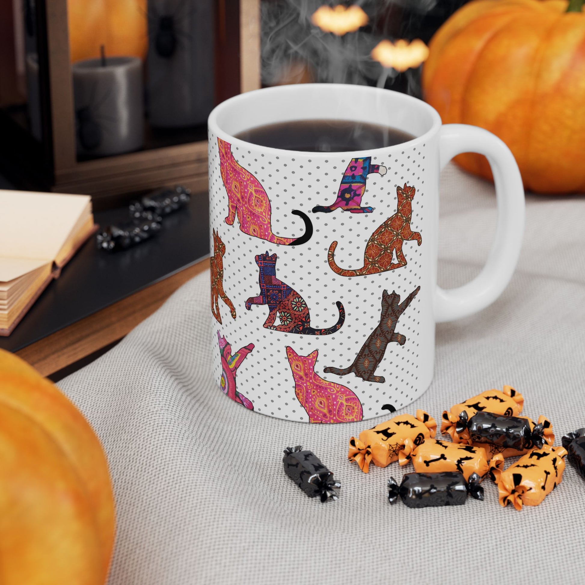 White mug with colorful cat pattern. 